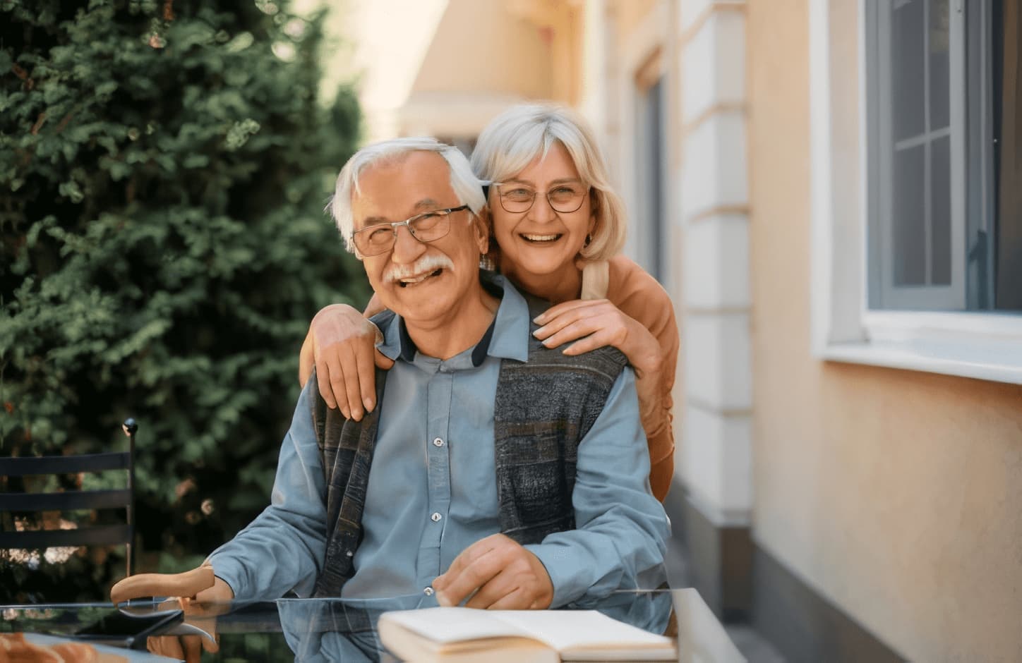 Happy senior couple at independent living community looking at camera